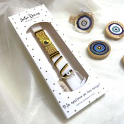 Λαμπάδα αρωματική λευκή με κορδόνια και ματόχαντρα